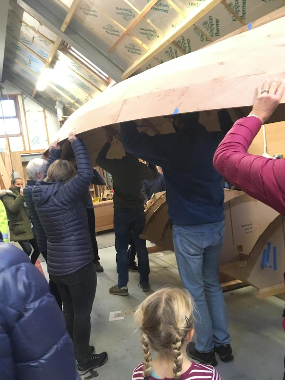 Many hands make light work of turning the skiff